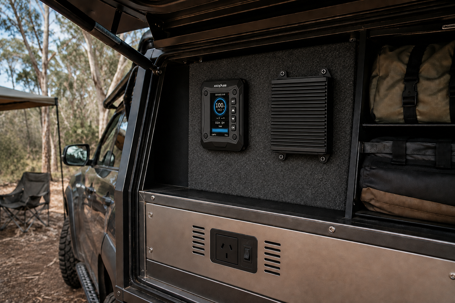 Flush-mounted inverter below a KickAss battery monitor and larger DC-DC charger in a 4x4 canopy